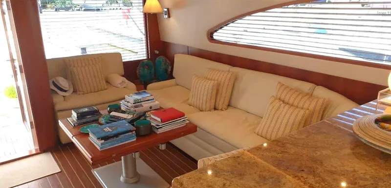 Bouki Yacht Photos Pics Luxurious 2006 Bertram 670 yacht interior with cozy seating and elegant decor.