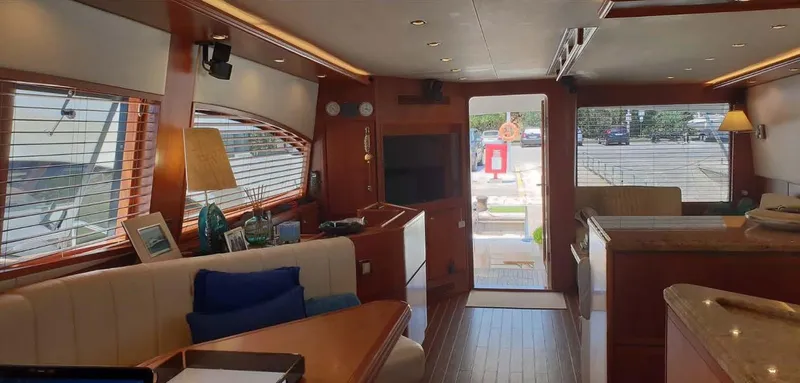 Bouki Yacht Photos Pics Luxurious interior of a 2006 Bertram 670 yacht with elegant wood finishes.