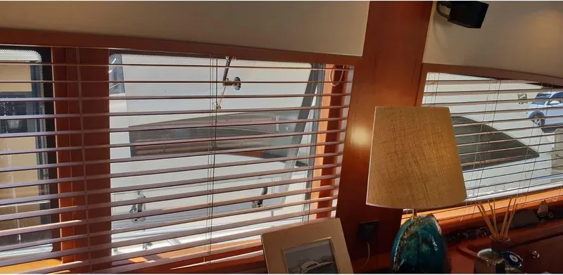 Bouki Yacht Photos Pics Interior view of a 2006 Bertram 670 yacht through window blinds.