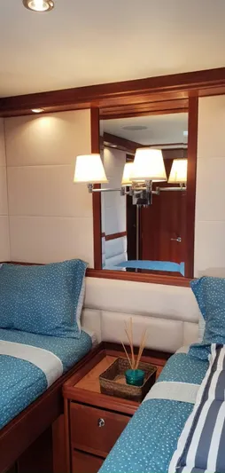 Bouki Yacht Photos Pics Cozy Bertram 670 2006 yacht cabin with twin beds and elegant decor.