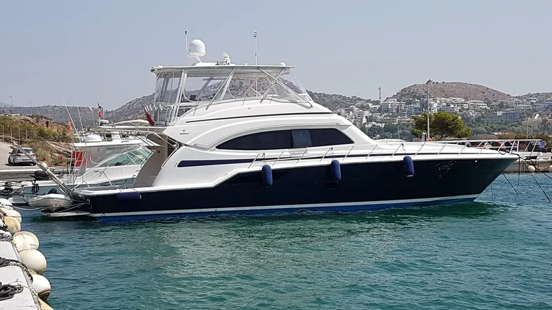 Bouki Yacht Photos Pics Luxury Bertram 670 yacht docked in a marina, 2006 model.