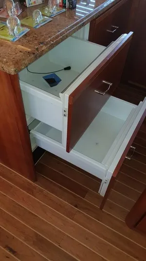 Bouki Yacht Photos Pics Open wooden drawers in a Bertram 670 yacht kitchen, 2006 model.