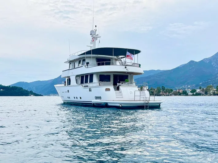 Annamia Yacht Photos Pics Terranova Yachts T85, 2007 model, cruising on serene waters with mountainous backdrop.
