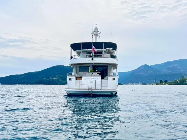 Annamia Yacht Photos Pics Terranova Yachts T85, 2007 model, on serene water with mountainous backdrop.