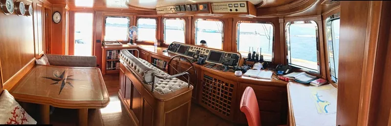 Annamia Yacht Photos Pics Luxurious interior of 2007 Terranova Yachts T85, featuring a spacious helm and elegant wood finishes.