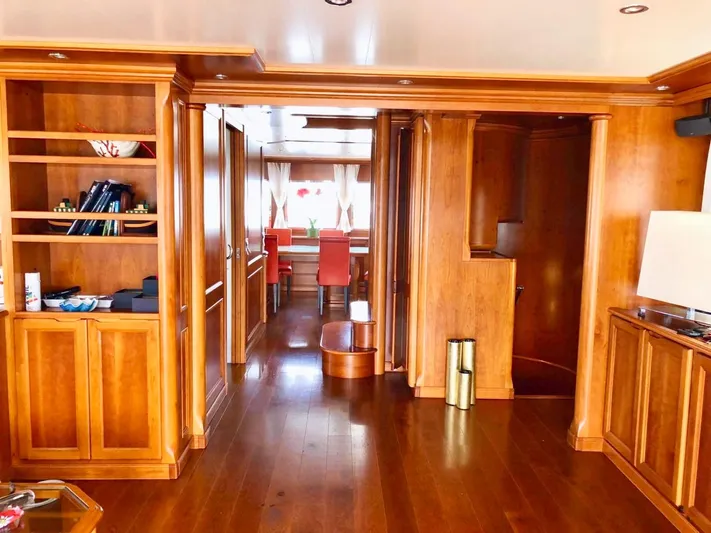 Annamia Yacht Photos Pics Luxurious wooden interior of 2007 Terranova Yachts T85, featuring elegant furnishings and warm lighting.