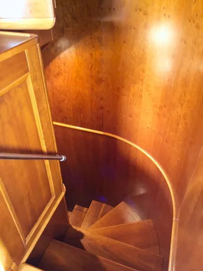 Annamia Yacht Photos Pics Wooden spiral staircase inside 2007 Terranova Yachts T85, showcasing elegant craftsmanship.