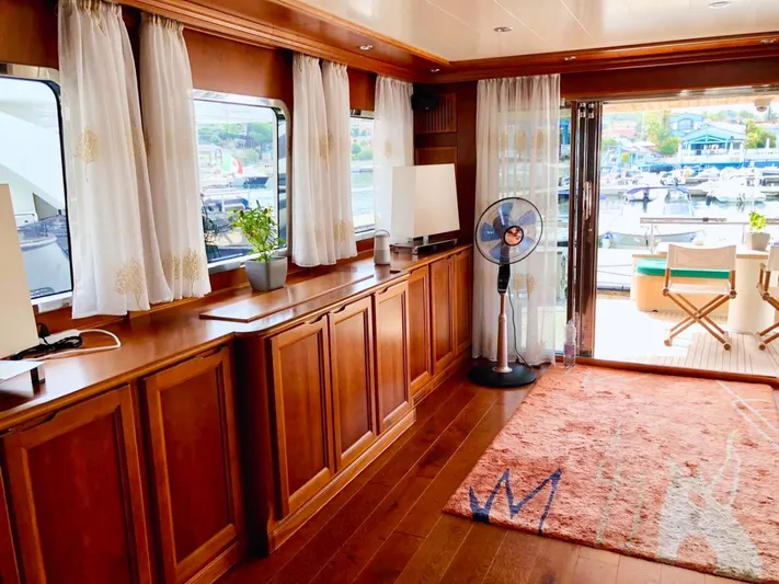 Annamia Yacht Photos Pics Luxurious interior of 2007 Terranova Yachts T85 with wooden cabinetry and marina view.
