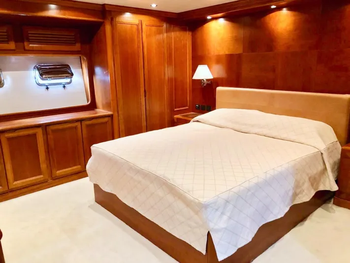 Annamia Yacht Photos Pics Luxurious cabin interior of 2007 Terranova Yachts T85 with wooden finishes and cozy bed.