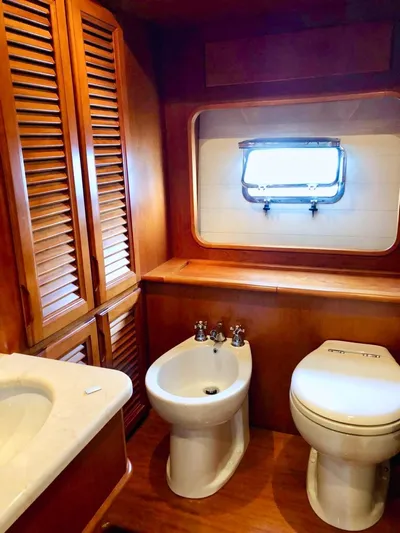 Annamia Yacht Photos Pics Luxurious 2007 Terranova Yachts T85 bathroom with wooden cabinetry and modern fixtures.