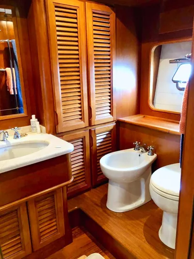Annamia Yacht Photos Pics Luxurious wooden bathroom interior on 2007 Terranova Yachts T85, featuring sink, bidet, and toilet.