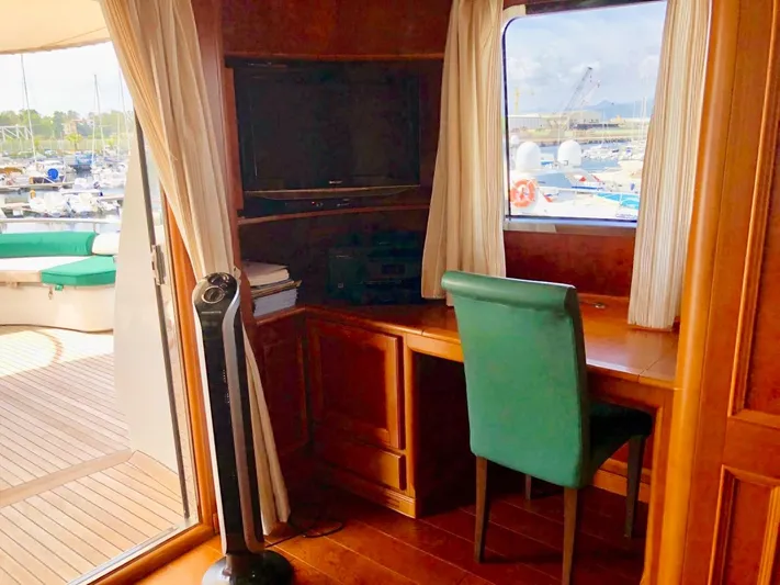 Annamia Yacht Photos Pics Interior of 2007 Terranova Yachts T85 with desk, chair, and window view of marina.