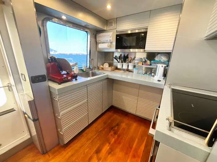 Annamia Yacht Photos Pics Modern kitchen interior on 2007 Terranova Yachts T85, featuring sleek cabinetry and ocean view.