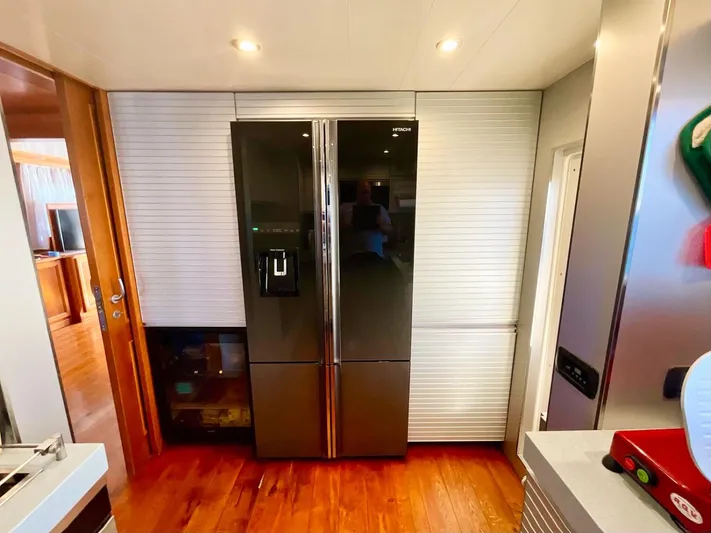 Annamia Yacht Photos Pics Modern kitchen on 2007 Terranova Yachts T85 with sleek refrigerator and wooden flooring.