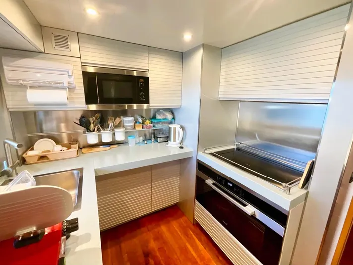 Annamia Yacht Photos Pics Modern kitchen in 2007 Terranova Yachts T85, featuring sleek appliances and wooden flooring.