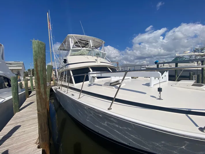  Yacht Photos Pics 1982 Bertram 46.6 War Wagon yacht docked under clear blue sky.