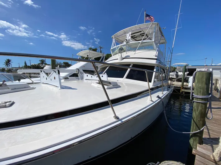  Yacht Photos Pics 1982 Bertram 46.6 War Wagon yacht docked under clear blue sky.