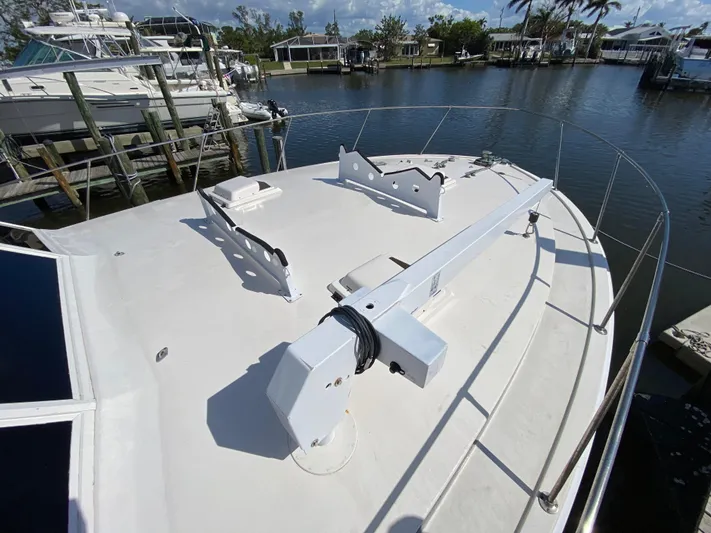  Yacht Photos Pics 1982 Bertram 46.6 War Wagon yacht deck, docked in a marina with surrounding boats.