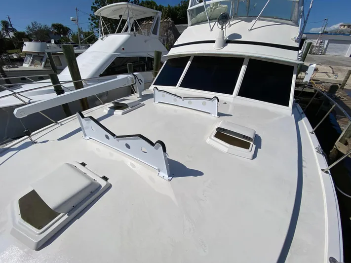  Yacht Photos Pics 1982 Bertram 46.6 War Wagon yacht docked, showcasing spacious deck and sleek design.