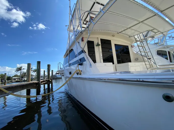  Yacht Photos Pics 1982 Bertram 46.6 War Wagon yacht docked, showcasing sleek design under a clear blue sky.