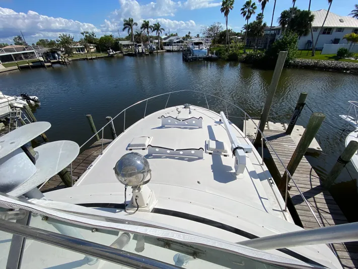  Yacht Photos Pics 1982 Bertram 46.6 War Wagon yacht docked in a scenic marina.