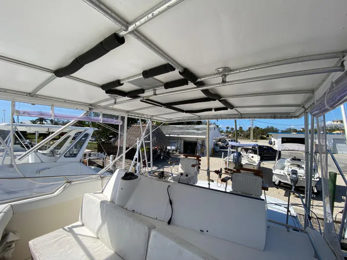  Yacht Photos Pics 1982 Bertram 46.6 War Wagon boat interior with seating and canopy.