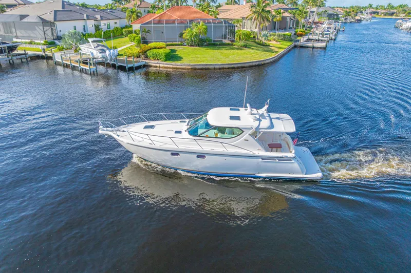  Yacht Photos Pics 2011 Tiara Yachts 4300 Sovran cruising in a scenic waterfront neighborhood.