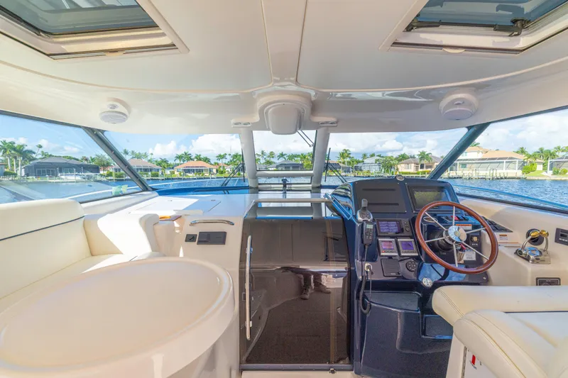  Yacht Photos Pics Interior view of 2011 Tiara Yachts 4300 Sovran, featuring helm and luxurious seating.