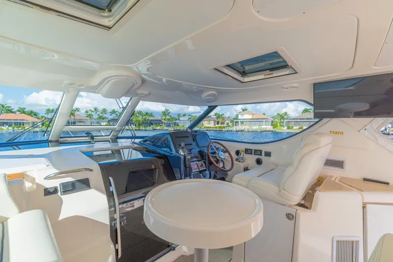  Yacht Photos Pics Luxurious interior of 2011 Tiara Yachts 4300 Sovran with helm and seating area.