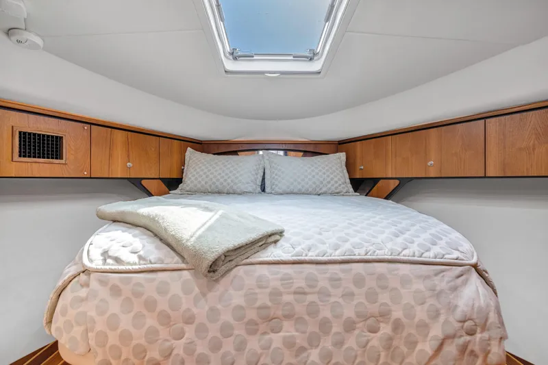  Yacht Photos Pics Cozy bedroom in 2011 Tiara Yachts 4300 Sovran with skylight and wooden cabinets.