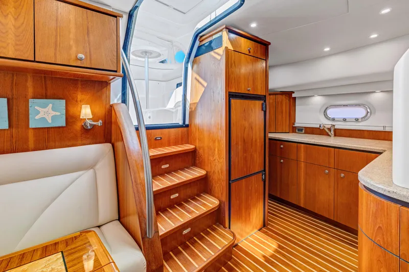 Yacht Photos Pics Luxurious interior of 2011 Tiara Yachts 4300 Sovran with wooden cabinetry and modern kitchen.
