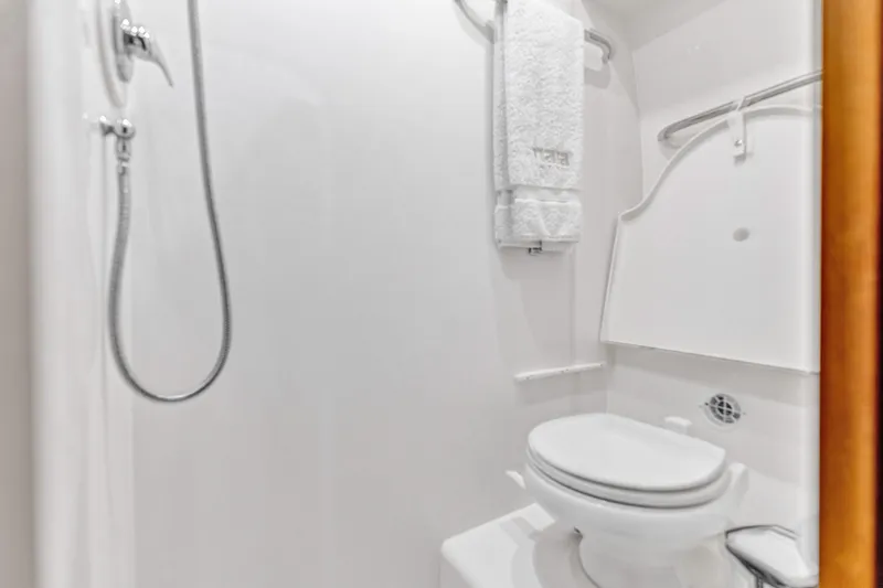  Yacht Photos Pics Bathroom interior of 2011 Tiara Yachts 4300 Sovran, featuring shower and toilet.