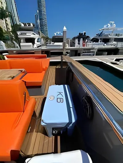 One Love Yacht Photos Pics Luxurious 2019 Fjord 52 Open yacht with orange seating and blue cooler on deck.