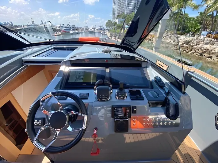 One Love Yacht Photos Pics 2019 Fjord 52 Open yacht helm with modern controls and waterfront view.