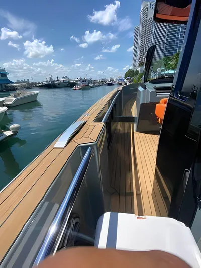 One Love Yacht Photos Pics 2019 Fjord 52 Open yacht docked at marina, sunny day, modern design, luxury boating.