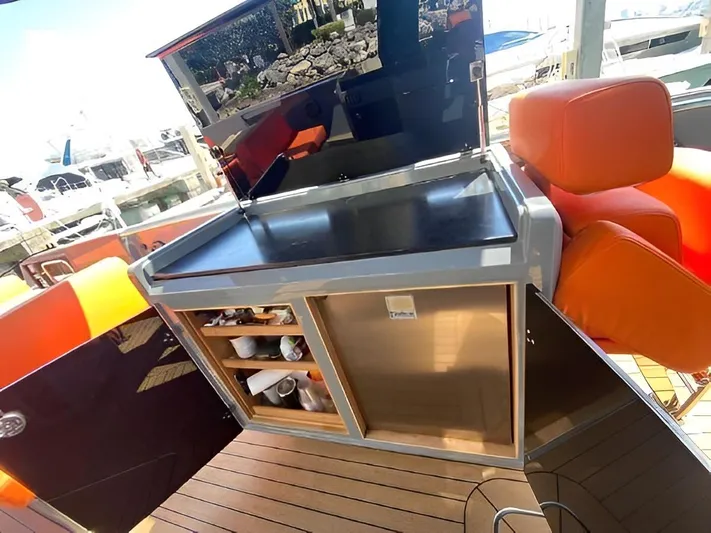 One Love Yacht Photos Pics Outdoor kitchen on 2019 Fjord 52 Open yacht with orange seating and storage.