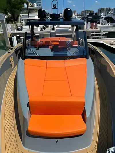One Love Yacht Photos Pics 2019 Fjord 52 Open yacht with vibrant orange seating at a marina.