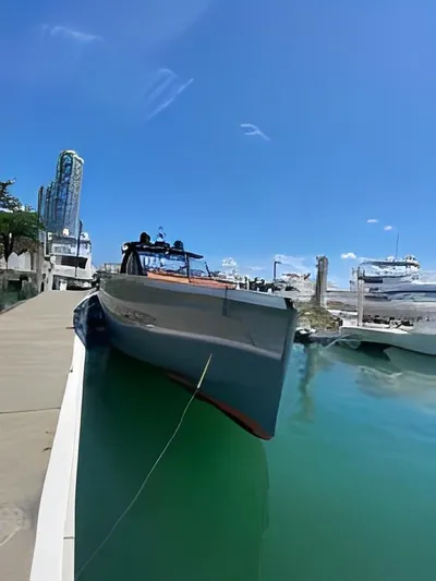 One Love Yacht Photos Pics 2019 Fjord 52 Open yacht docked in a marina under a clear blue sky.