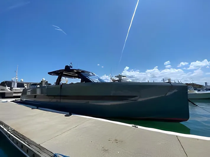 One Love Yacht Photos Pics 2019 Fjord 52 Open yacht docked under clear blue sky.
