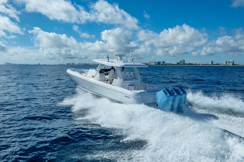  Yacht Photos Pics 2023 Intrepid 427 Nomad SE cruising on open ocean under blue sky.