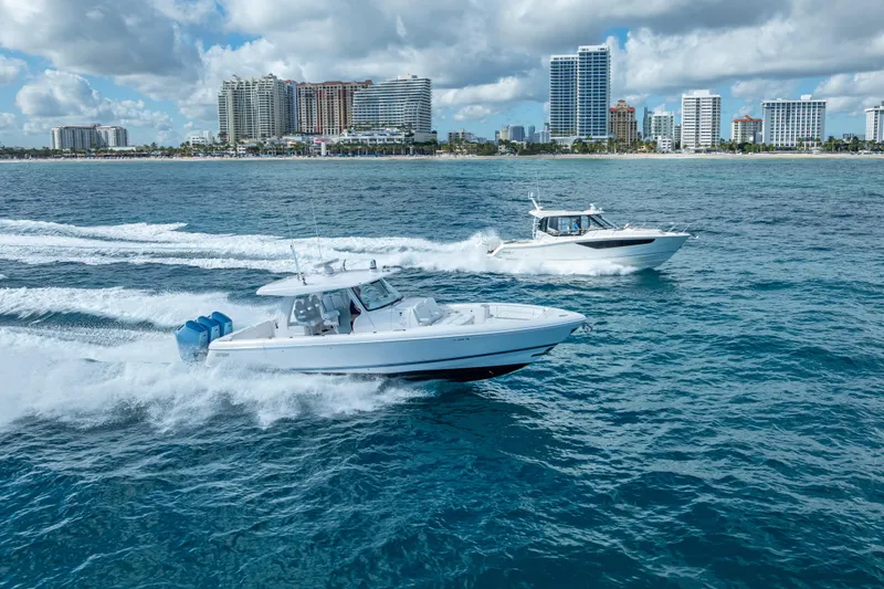  Yacht Photos Pics Two Intrepid 427 Nomad SE boats cruising near a city skyline, 2023 model.