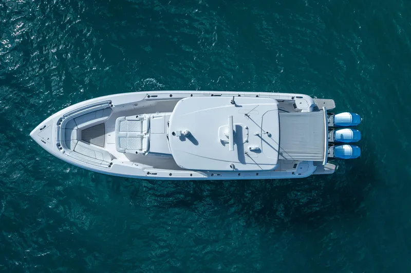  Yacht Photos Pics Aerial view of 2023 Intrepid 427 Nomad SE boat on blue ocean water.