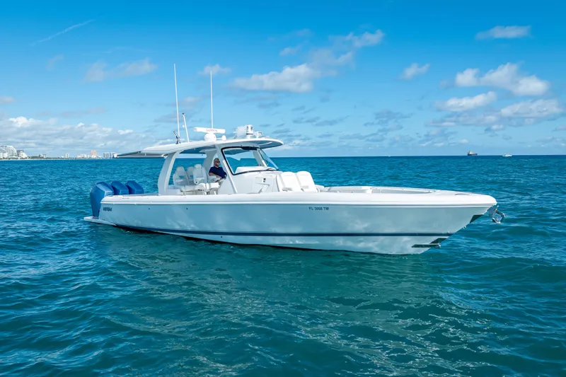  Yacht Photos Pics 2023 Intrepid 427 Nomad SE boat cruising on open blue ocean under clear sky.