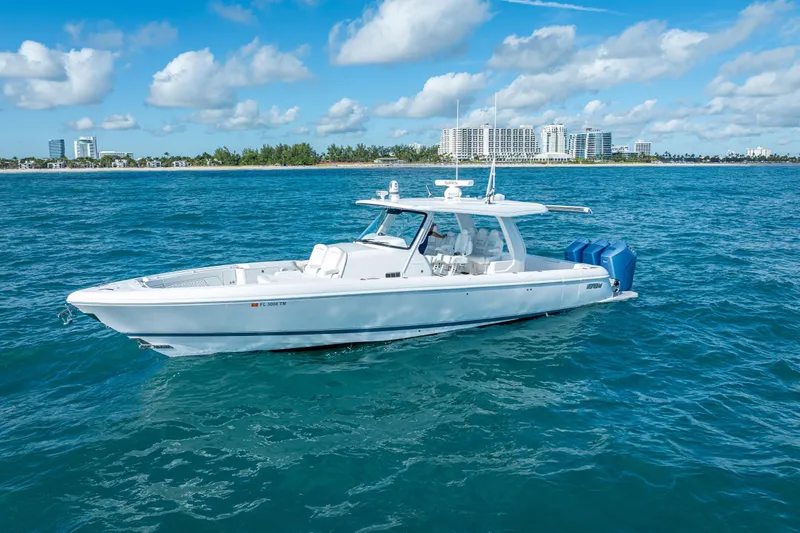  Yacht Photos Pics 2023 Intrepid 427 Nomad SE boat cruising on blue ocean near city skyline.