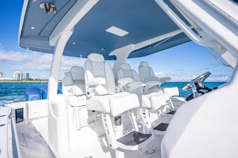  Yacht Photos Pics 2023 Intrepid 427 Nomad SE boat interior with luxurious seating and ocean view.