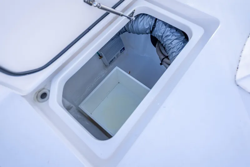  Yacht Photos Pics Open storage compartment on 2023 Intrepid 427 Nomad SE boat, showcasing interior details.