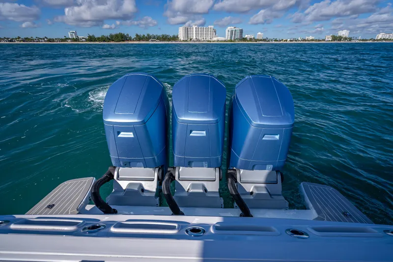  Yacht Photos Pics 2023 Intrepid 427 Nomad SE with triple outboard engines on open water.