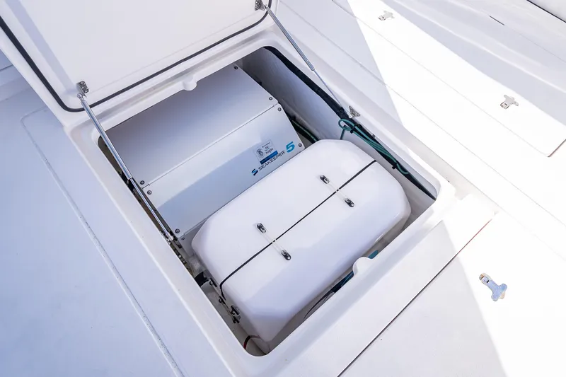  Yacht Photos Pics Open storage compartment on 2023 Intrepid 427 Nomad SE boat, showcasing internal equipment.