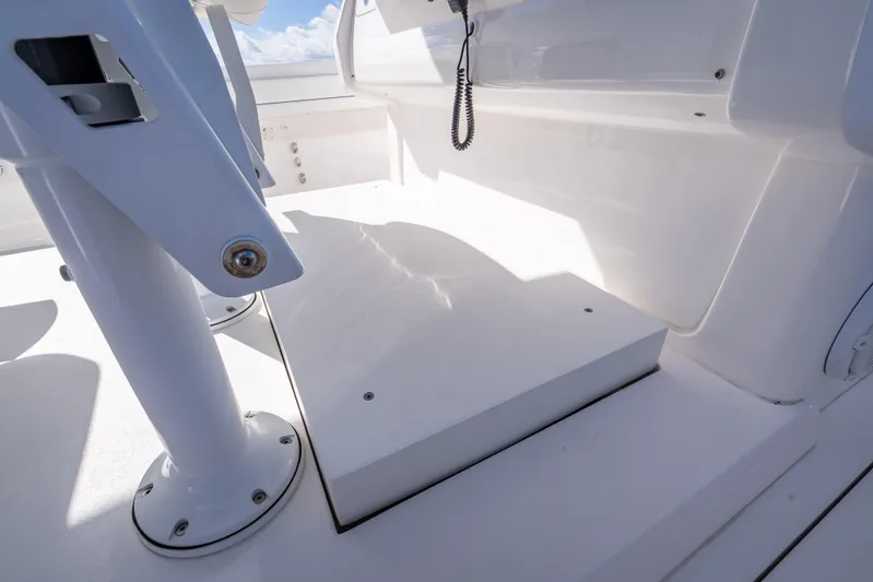  Yacht Photos Pics 2023 Intrepid 427 Nomad SE boat interior with white seating and fixtures.