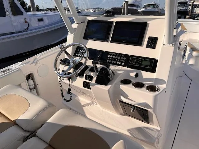 Johnny B' Good Yacht Photos Pics 2015 Edgewater 280CC boat cockpit with steering wheel and navigation controls.